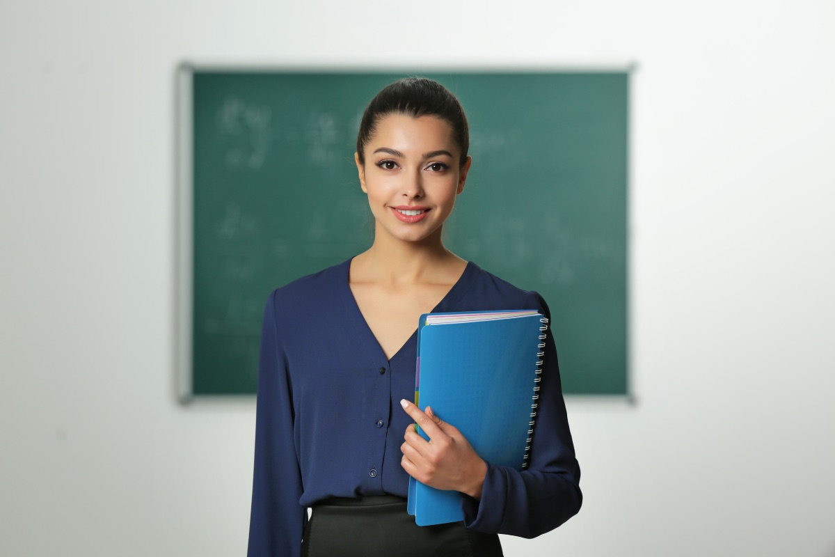 A teacher in a classroom setting, calm and engaged